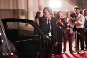 At the rally, the female bodyguard opens the car door for the politician.